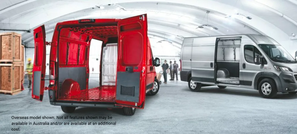 Two Fiat Ducato vans in a warehouse, one red and one white
