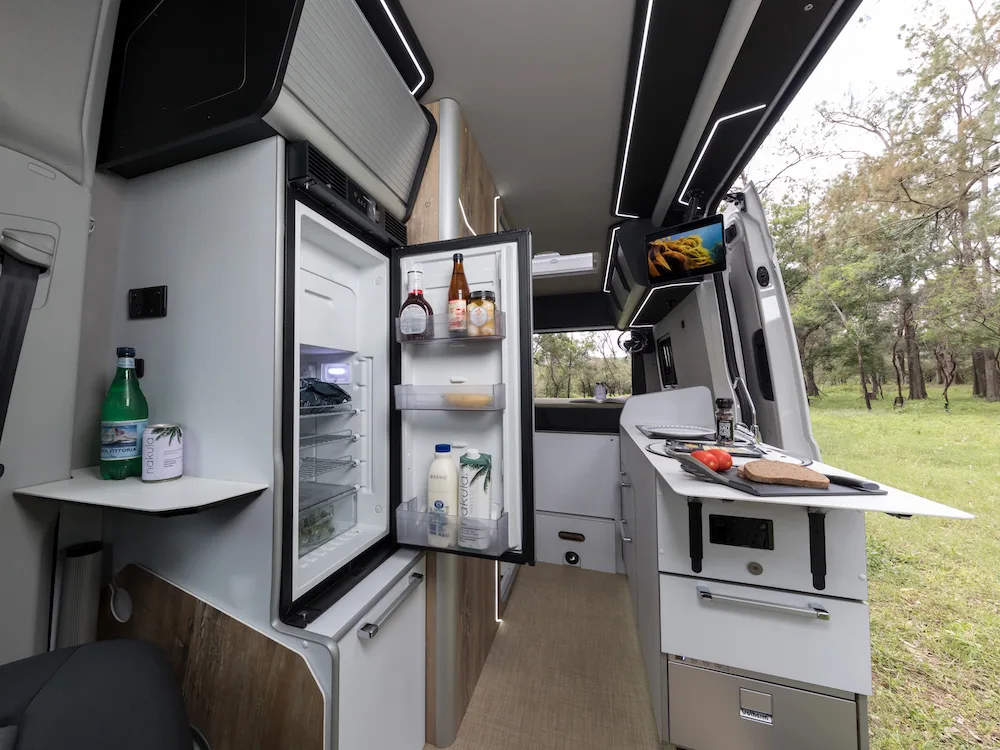 Inside the Trakka Akuna campervan showing the fridge open