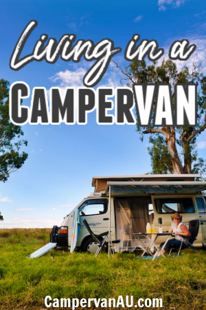 Lady sitting outside her campervan in a green field