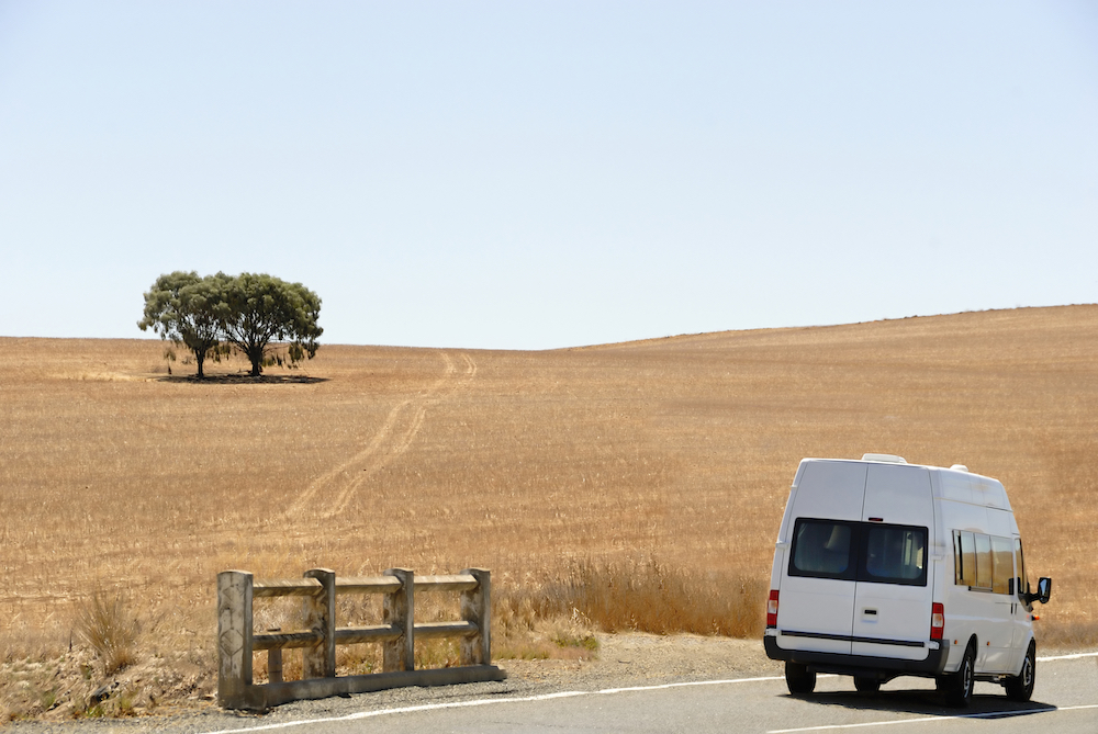 White campervan on a quiet road in Australia