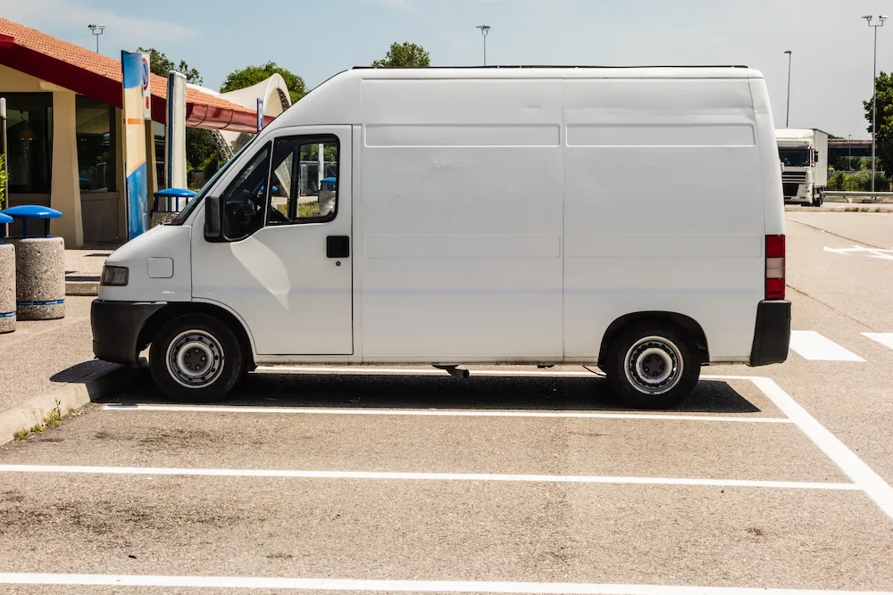 White campervan parked in a regular car space.