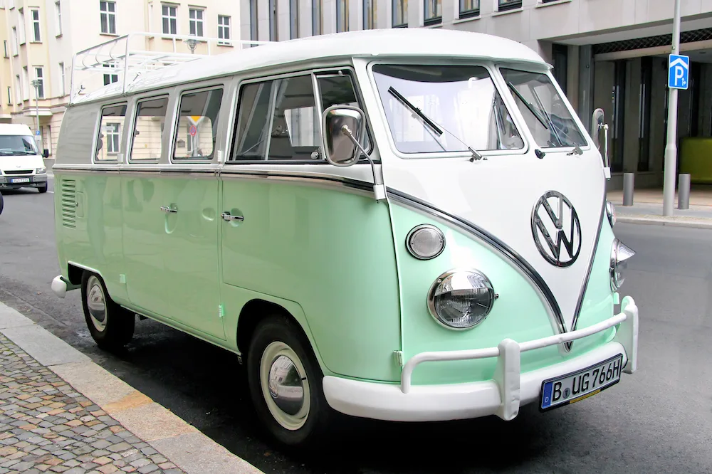 Mint green vintage VW Transporter van parked in city street