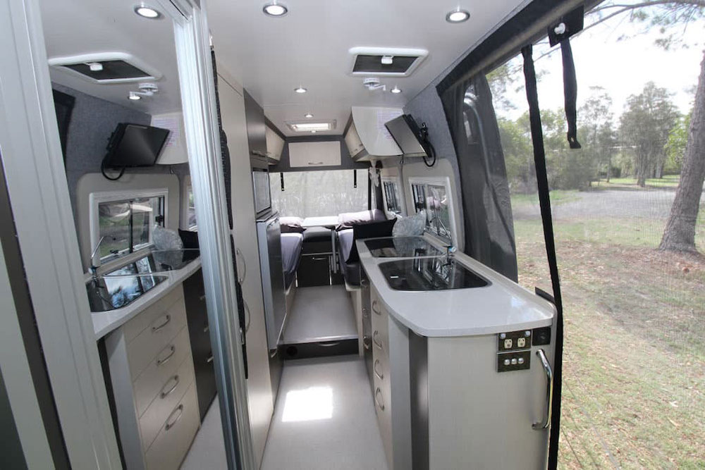 Interior view of the Wattle camper van looking towards the back of the van showing the double bed layout.