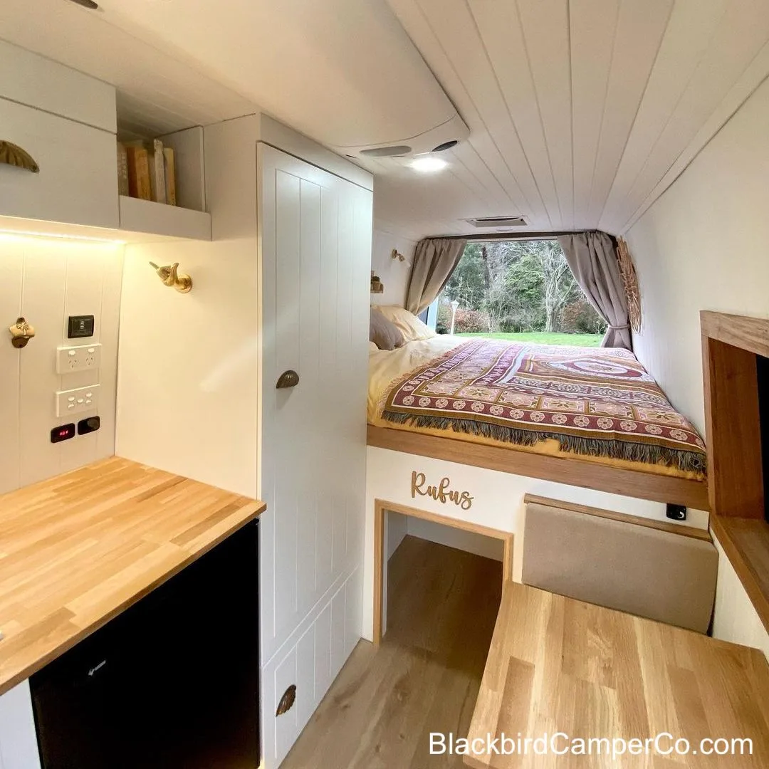 Interior of camper showing bed with dog bed underneath.