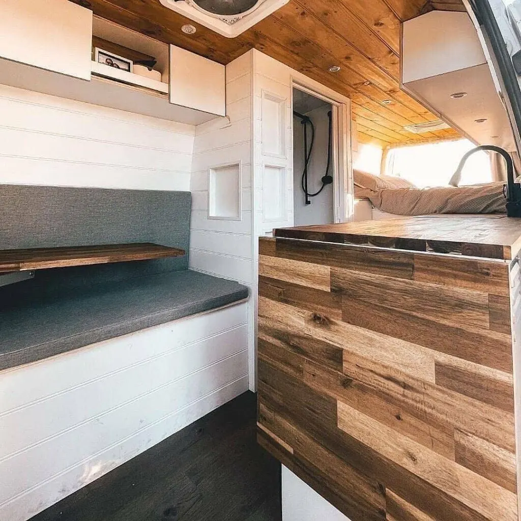Dining area and kitchen in a converted Sprinter campervan.