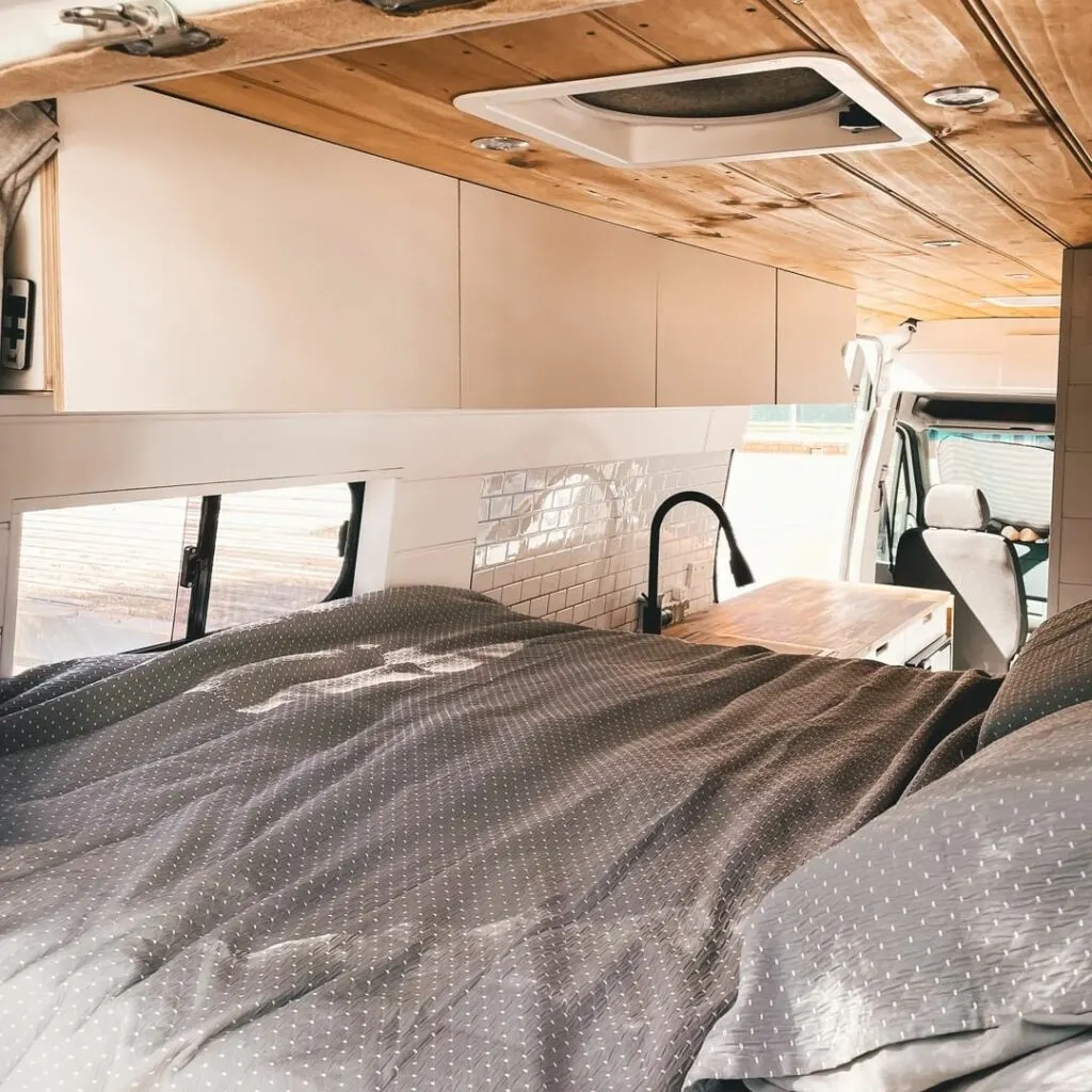 Bed end of a Mercedes Sprinter self converted camper van.