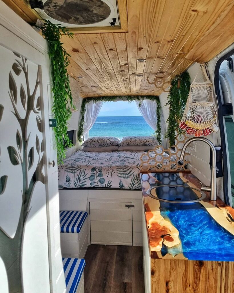 Interior of a converted Mercedes Sprinter van looking towards the bed in the back.