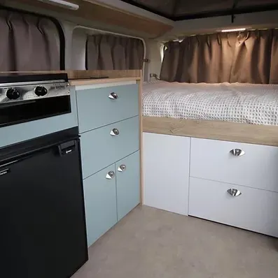 Bed and kitchen area inside the Jacana Hiker Toyota Hiace campervan.