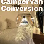 Cozy bed inside a campervan with text overlay that says: Gorgeous campervan conversion using a kitset.