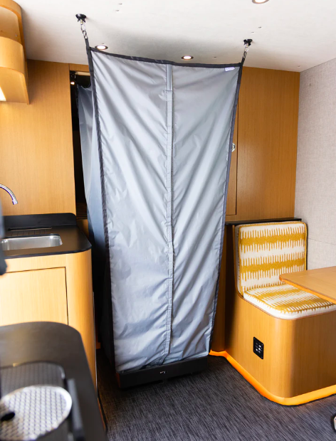 Folding Tetravan shower shown set up inside a campervan.