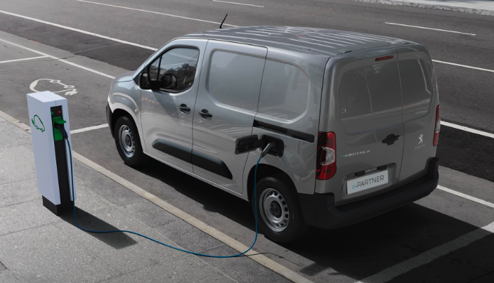 Peugot E-Partner electric van plugged in to a charging station.
