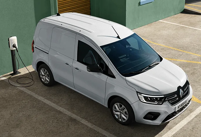 Looking down on a Renault Kangoo E-Tech electric van plugged in to a charging station.