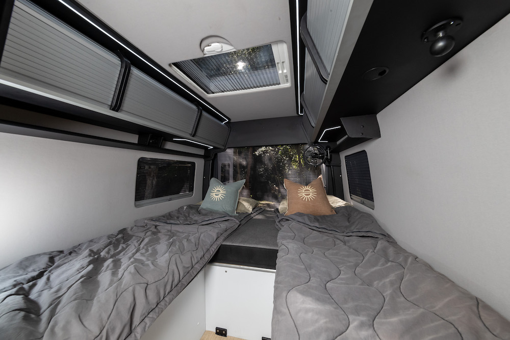 Bed area in the Trakka Akuna A2M campervan showing the single beds setup.