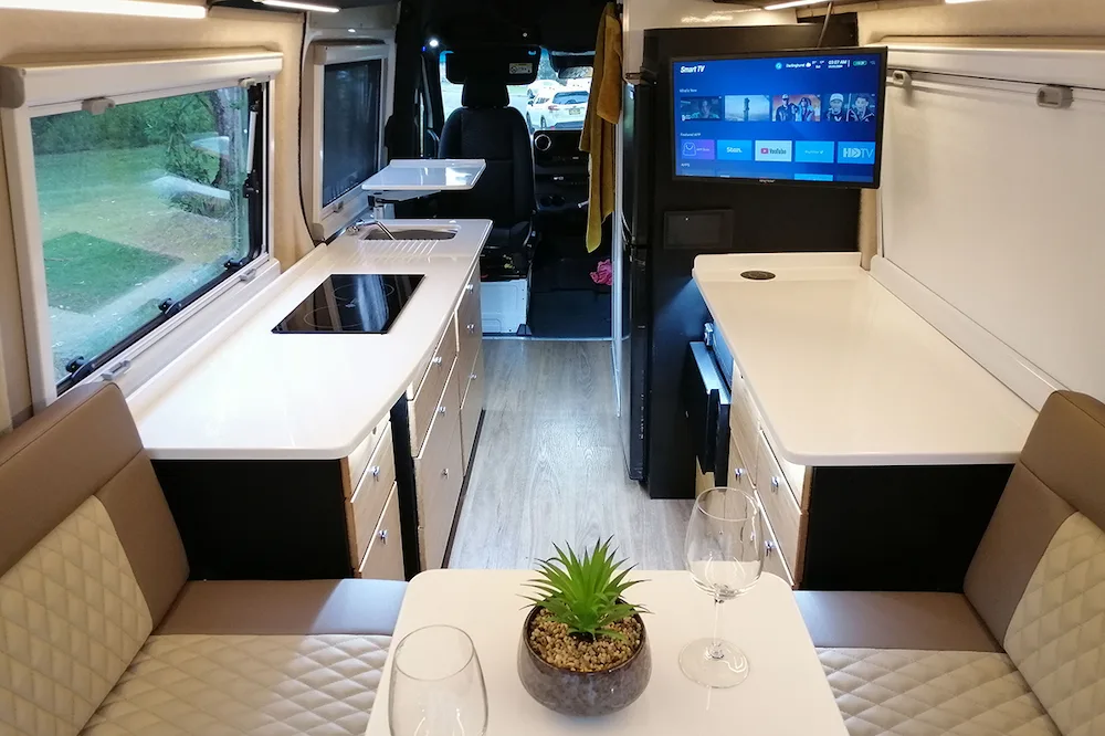 Interior view of a Kimberley Kampers Kruisewagen van showing the kitchen area from the back.