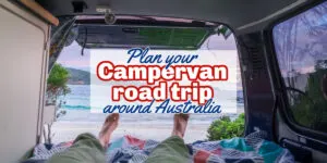 View from the bed of a camper van looking past a mans feet to the beach outside; with text overlay: Plan your campervan road trip around Australia.
